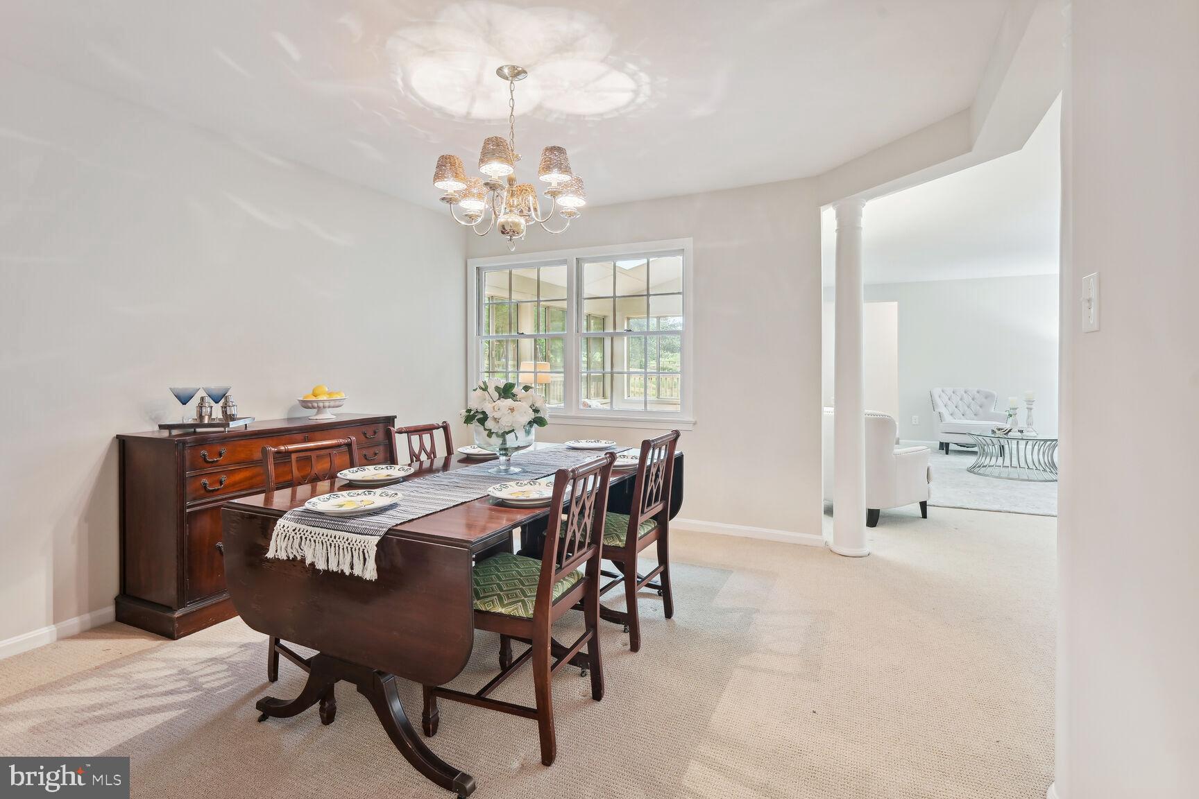 7413 Miller Fall Road Rockville, MD 20855 - Photo 12 of 63 Dining room with chandelier and decorative columns