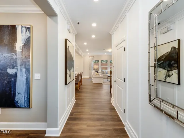 a view of a hallway with wooden floor and staircase