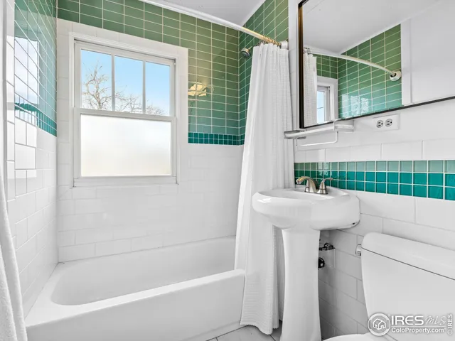 a bathroom with a tub sink and window