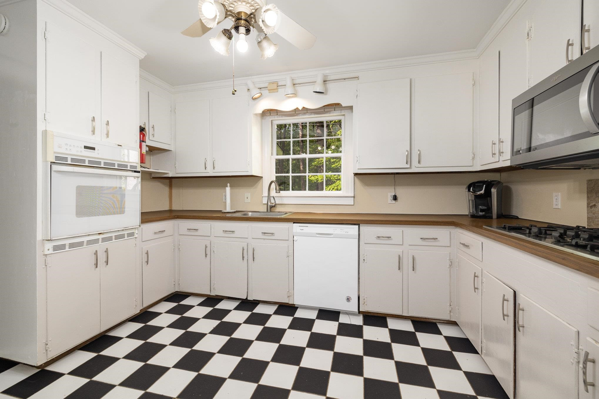 4921 Brookhaven Drive Raleigh, NC 27612 - Photo 10 of 39 White and bright Kitchen with the perfect view to your stunning back yard. Kitchen