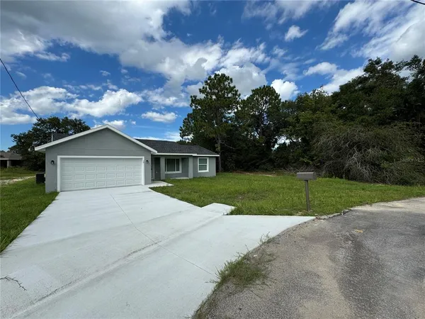 a front view of a house with yard