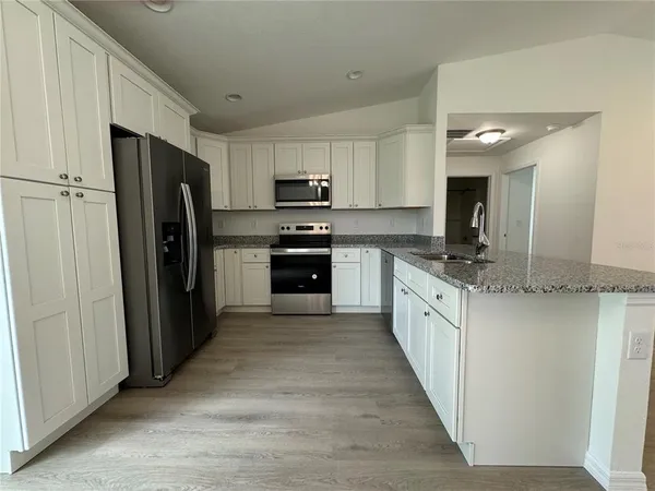 a large kitchen with cabinets