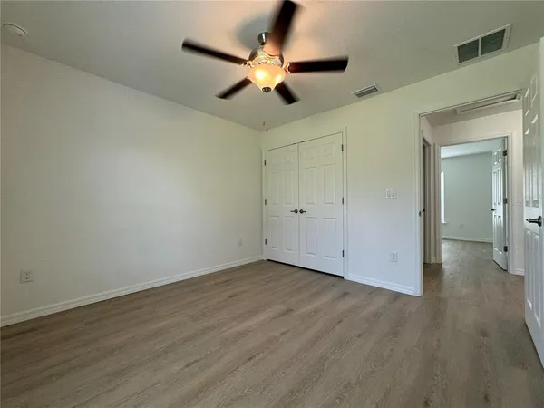 a view of an empty room and wooden floor