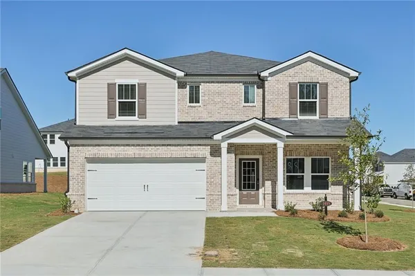a front view of a house with a yard