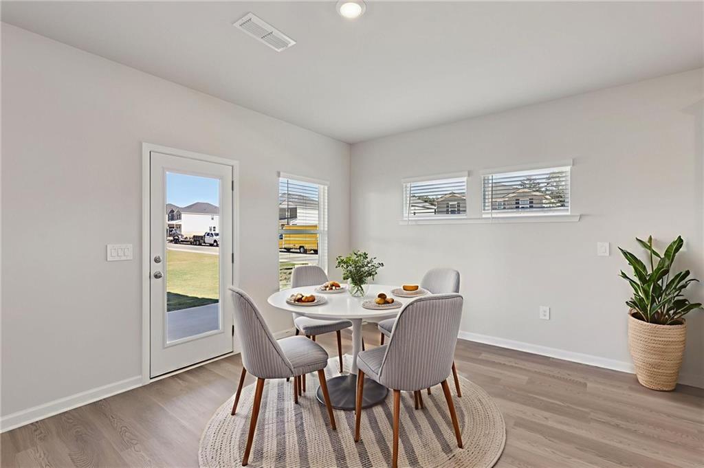 1489 High Fls Lane Grayson, GA 30017 - Photo 12 of 44 a dining room with furniture and wooden floor