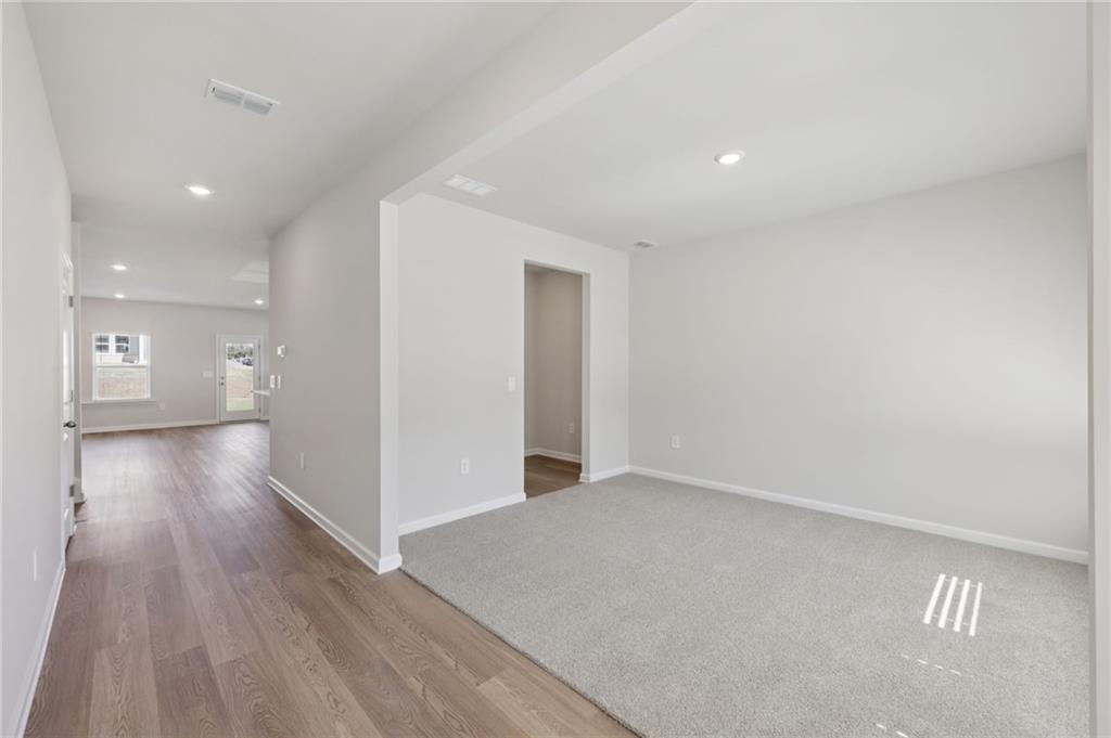 1489 High Fls Lane Grayson, GA 30017 - Photo 14 of 44 a view of a hallway with wooden floor