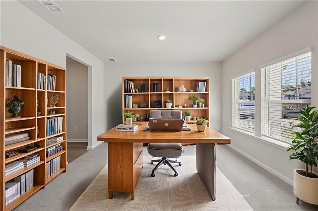 1489 High Fls Lane Grayson, GA 30017 - Photo 16 of 44 a dining room with a table and chairs