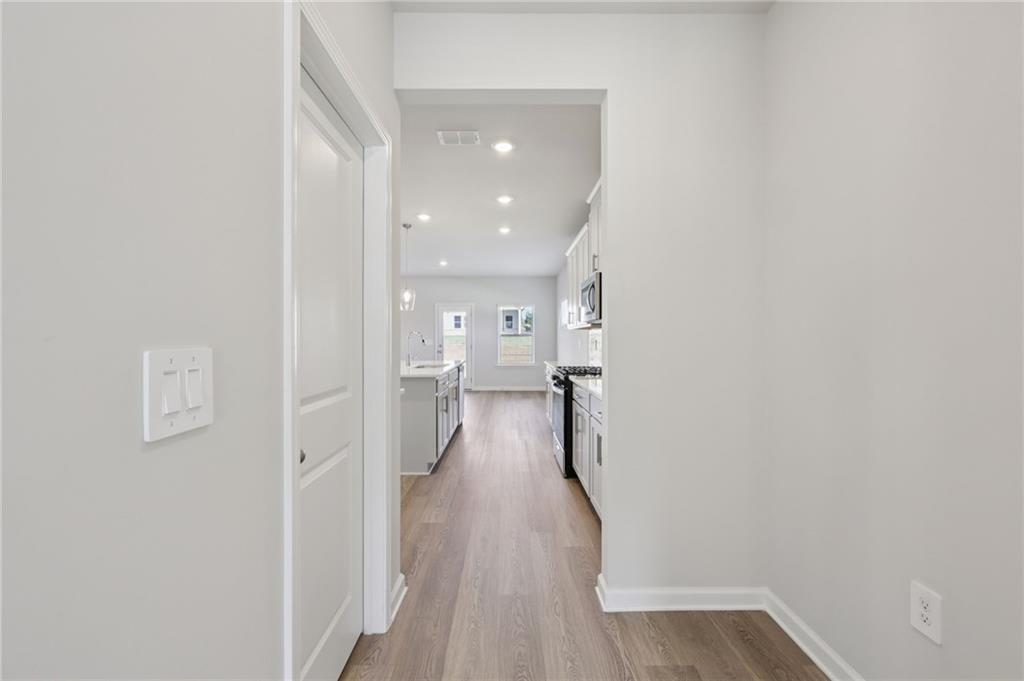 1489 High Fls Lane Grayson, GA 30017 - Photo 18 of 44 a view of a hallway with a wooden floor