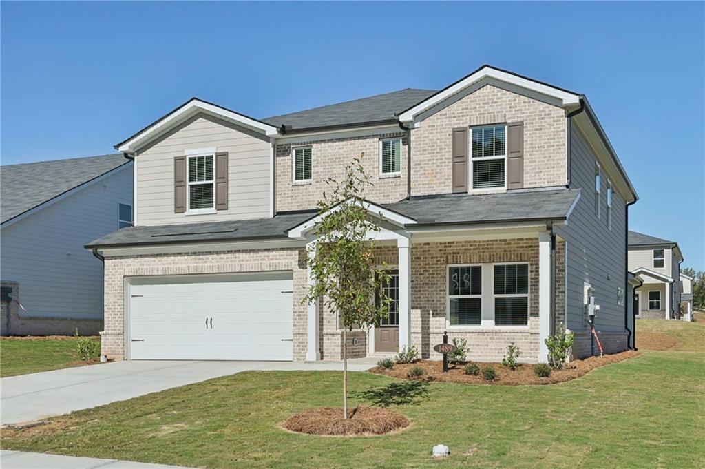 1489 High Fls Lane Grayson, GA 30017 - Photo 2 of 44 a front view of a house with a yard and garage