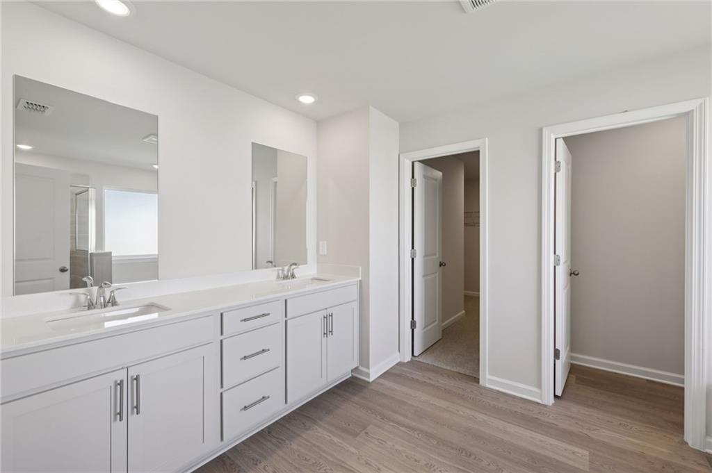 1489 High Fls Lane Grayson, GA 30017 - Photo 28 of 44 a spacious bathroom with a double vanity sink a mirror and a shower