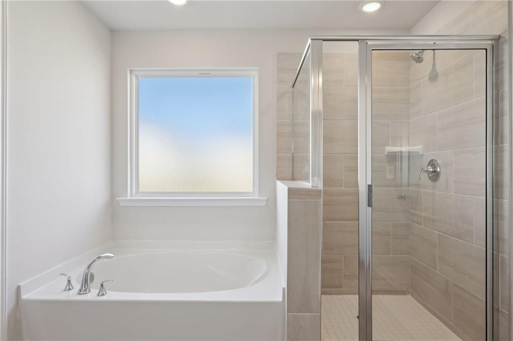 1489 High Fls Lane Grayson, GA 30017 - Photo 29 of 44 a white bath tub sitting next to a shower