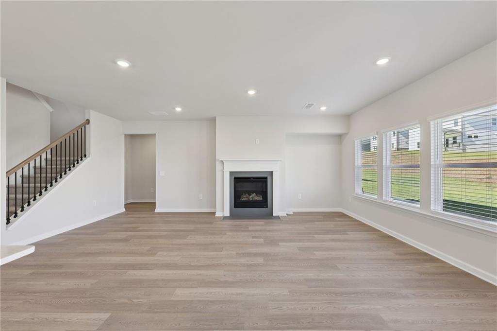 1489 High Fls Lane Grayson, GA 30017 - Photo 3 of 44 a view of an empty room with wooden floor and a window