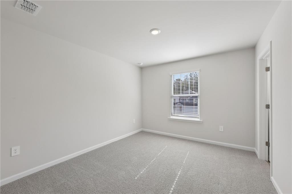 1489 High Fls Lane Grayson, GA 30017 - Photo 32 of 44 a view of an empty room with a window