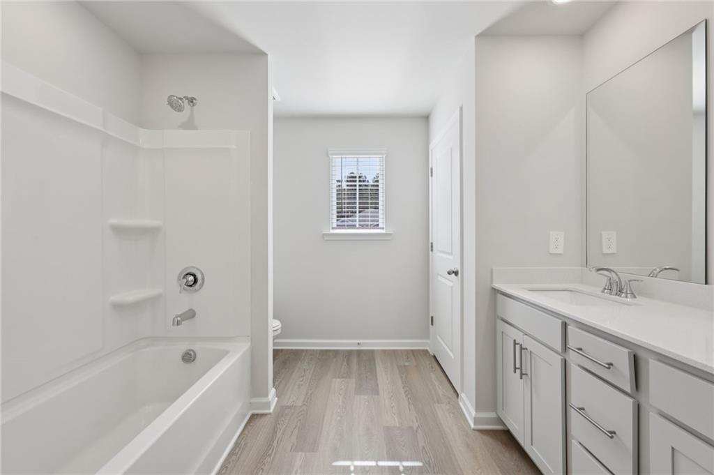 1489 High Fls Lane Grayson, GA 30017 - Photo 35 of 44 a bathroom with a tub sink and mirror
