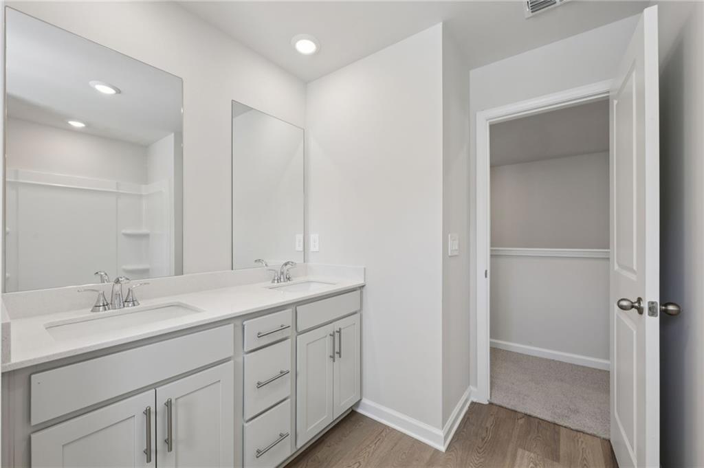 1489 High Fls Lane Grayson, GA 30017 - Photo 36 of 44 a bathroom with a double vanity sink and mirror