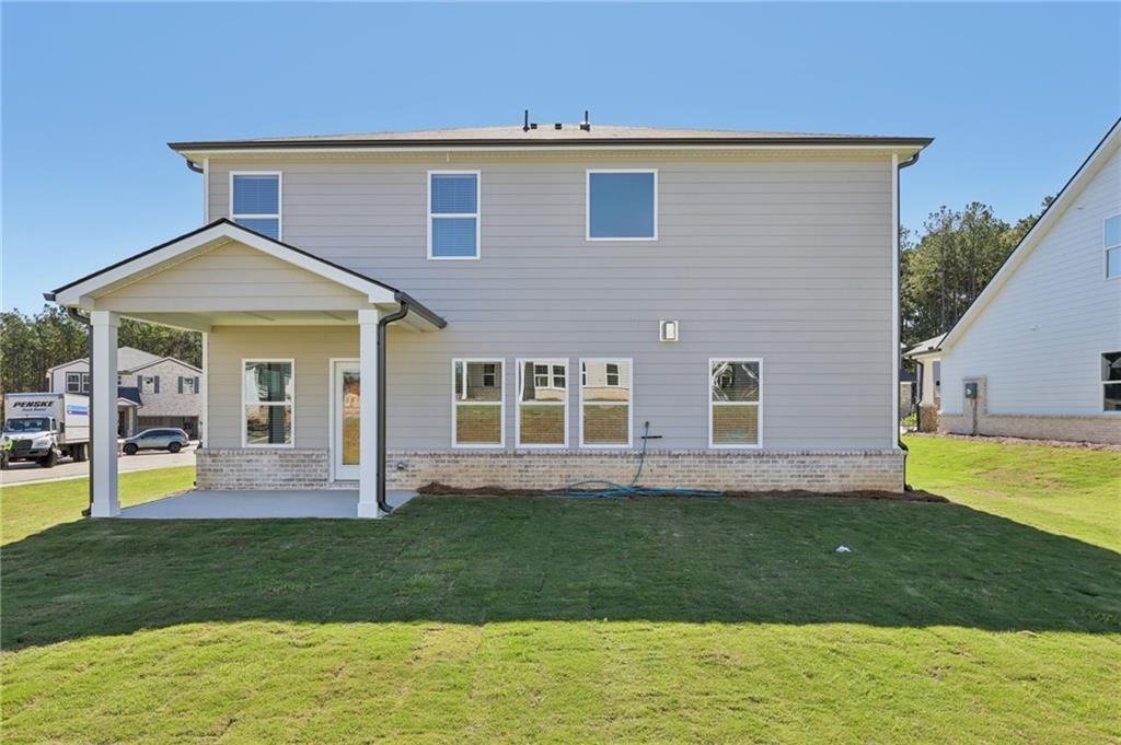 1489 High Fls Lane Grayson, GA 30017 - Photo 41 of 44 a front view of a house with a yard table and chairs