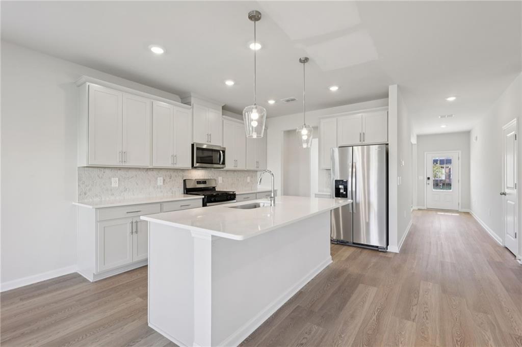 1489 High Fls Lane Grayson, GA 30017 - Photo 10 of 44 a kitchen with stainless steel appliances a refrigerator sink and microwave