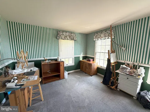 a bedroom with furniture and a window