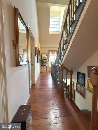 a view of entryway and hall with wooden floor