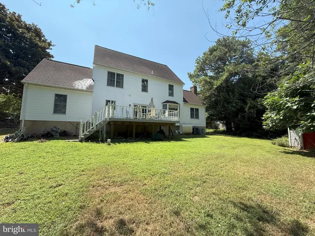 a front view of house with yard and trees
