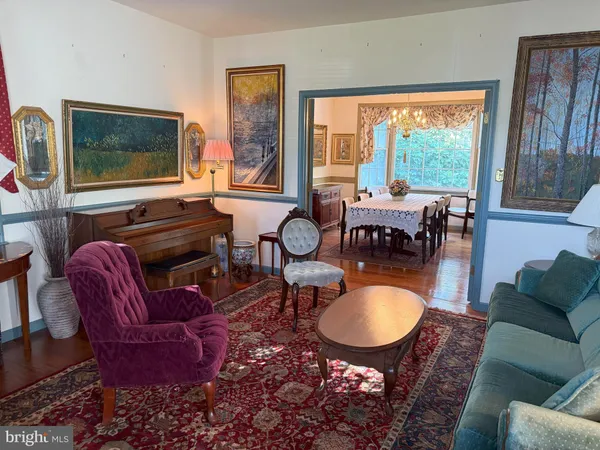 a living room with furniture a flat screen tv and a floor to ceiling window