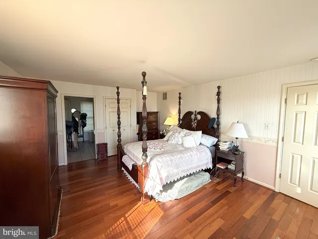 a bedroom with a bed and a mirror