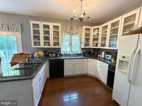 a kitchen with stainless steel appliances granite countertop a stove and a refrigerator