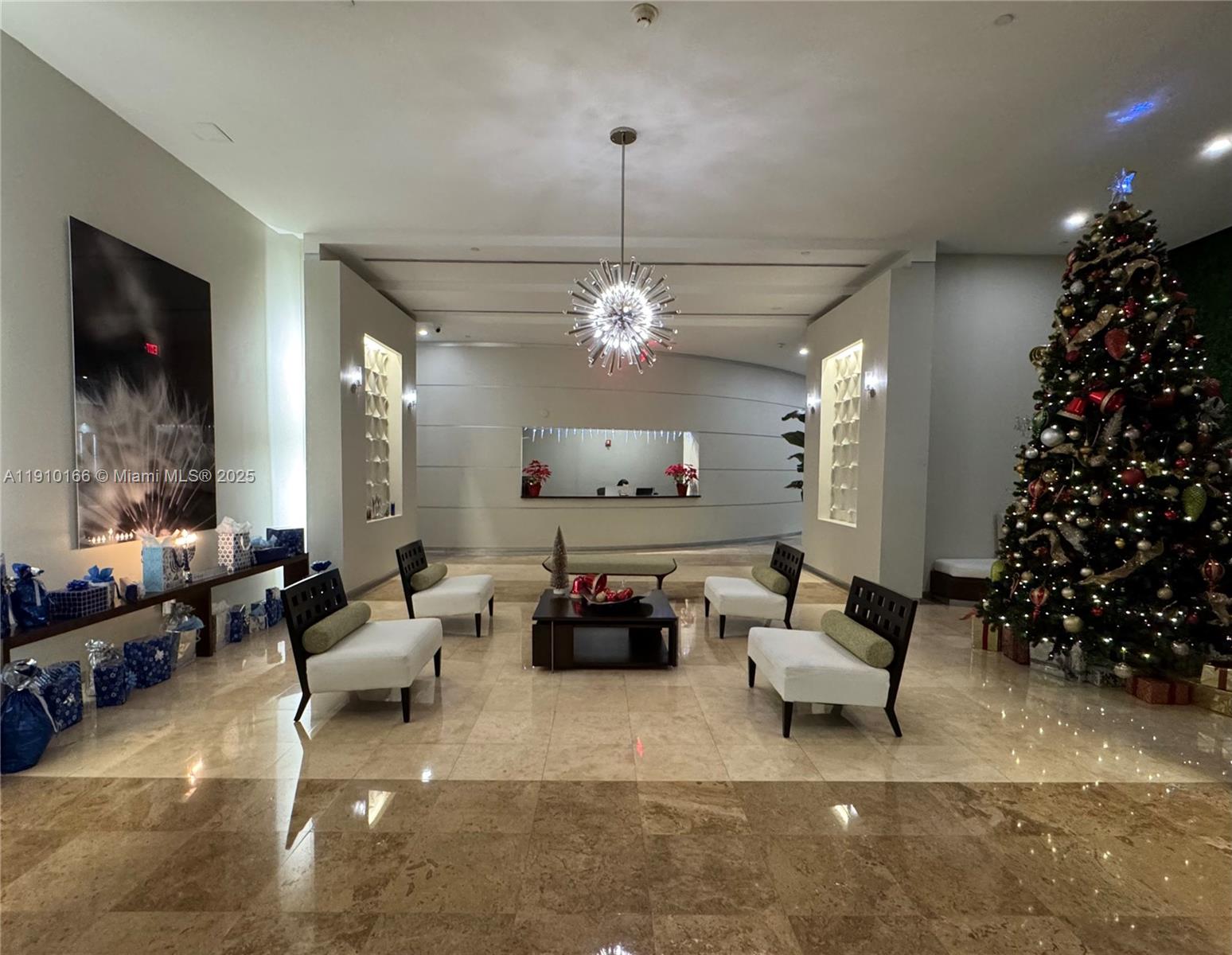 9055 Southwest 73rd Court, Unit 406 Miami, FL 33156 - Photo 15 of 18 a living room with furniture and a chandelier