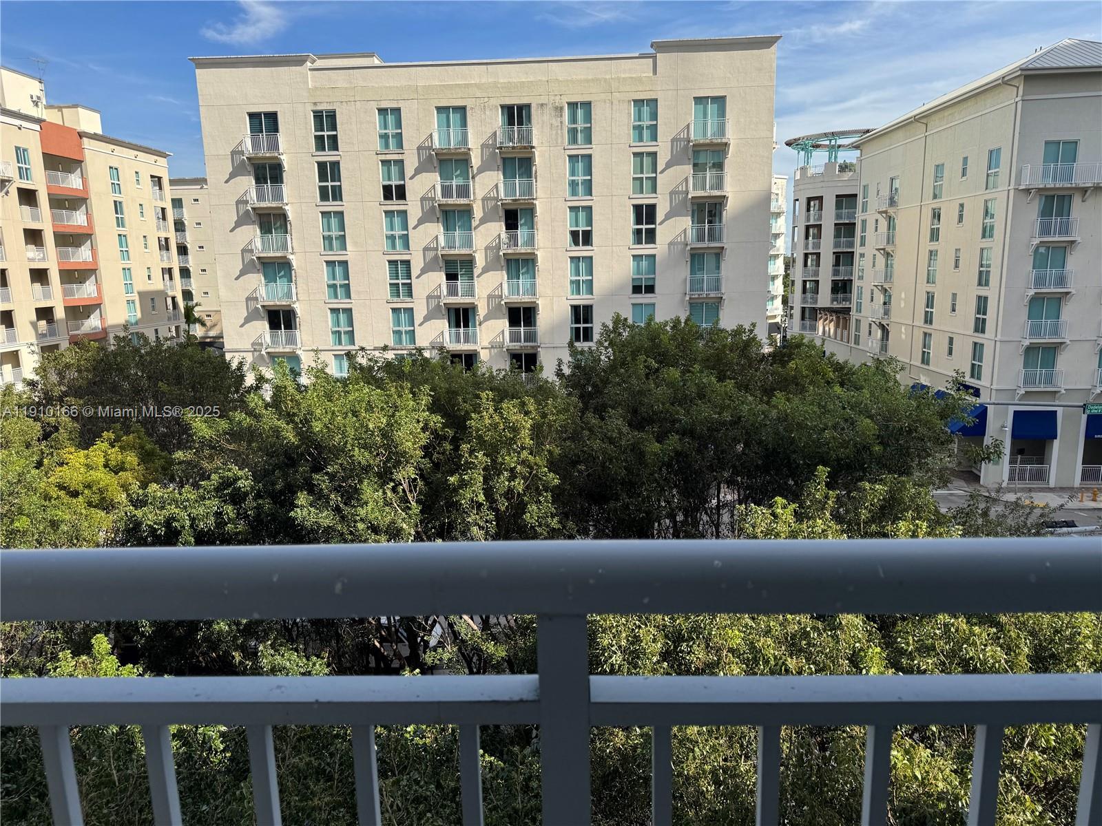 9055 Southwest 73rd Court, Unit 406 Miami, FL 33156 - Photo 18 of 18 a view of a large building with an outdoor space