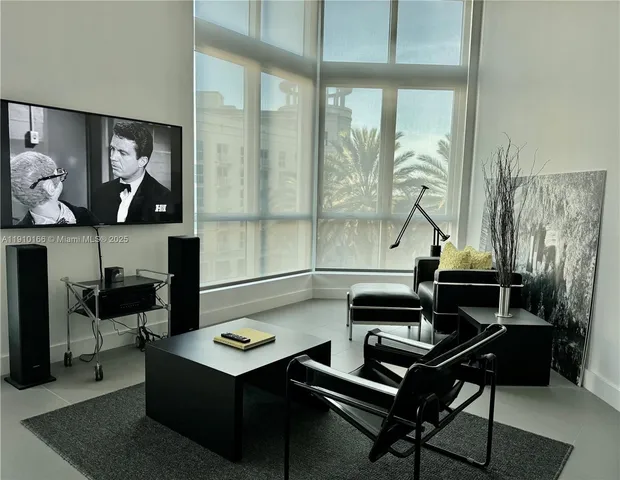 a living room with furniture and a piano