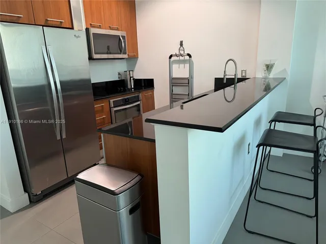 a kitchen with stainless steel appliances a refrigerator and a sink