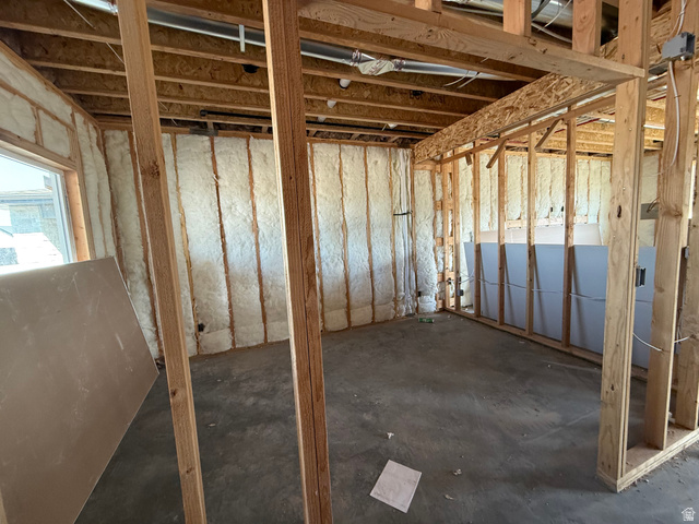 3318 South 1000 West Logan, UT 84321 - Photo 7 of 12 Unfinished interior space featuring exposed wood framing, spray foam insulation, concrete flooring, and an installed window