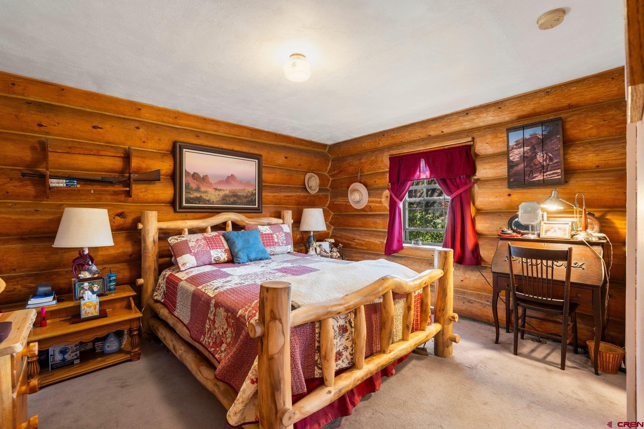 3515 County Road 514 Ignacio, CO 81137 - Photo 23 of 35 a bedroom with a bed and a chandelier