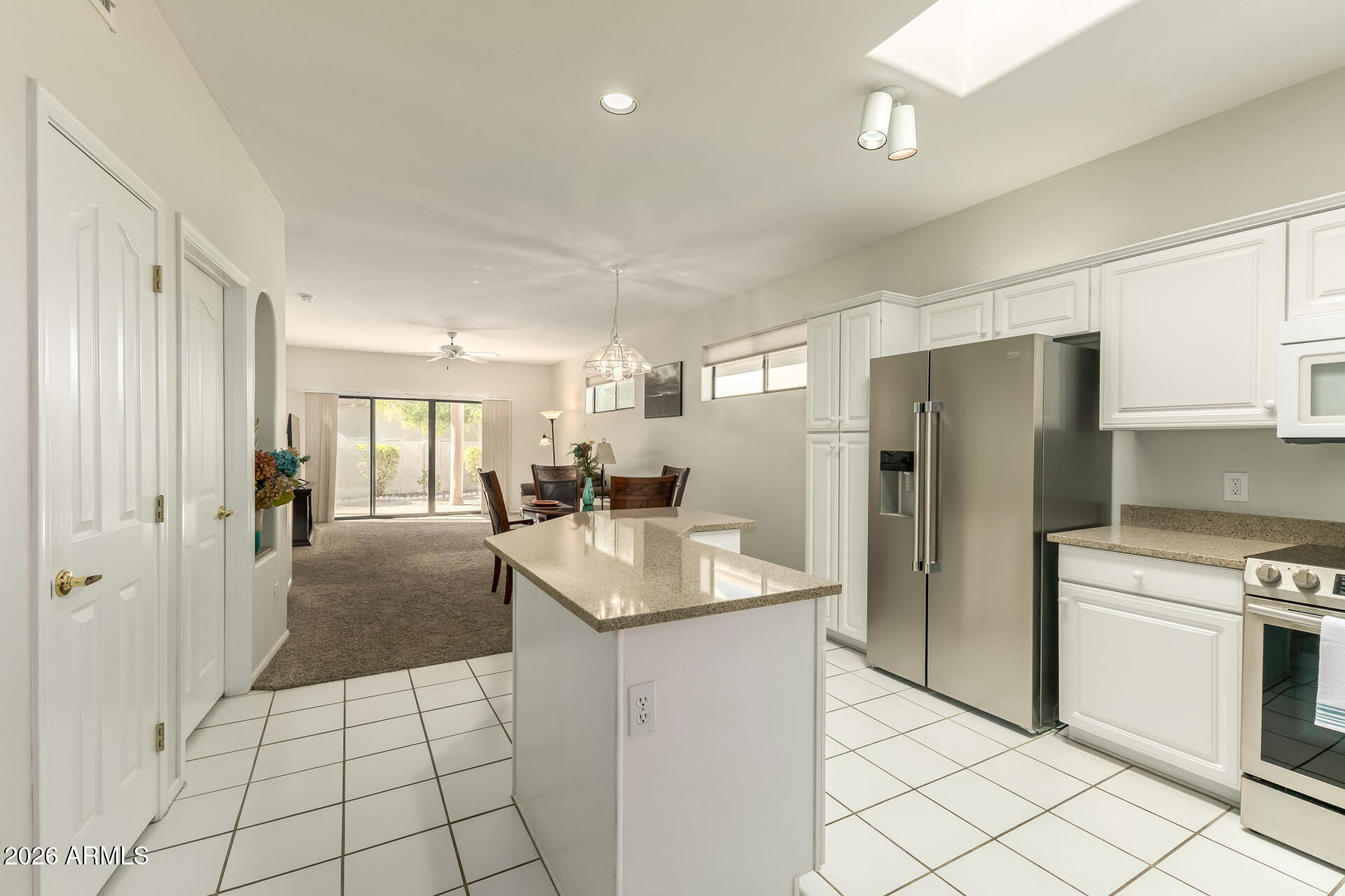 5445 East McKellips Road, Unit 23 Mesa, AZ 85215 - Photo 11 of 32 a kitchen with a refrigerator a sink and a stove