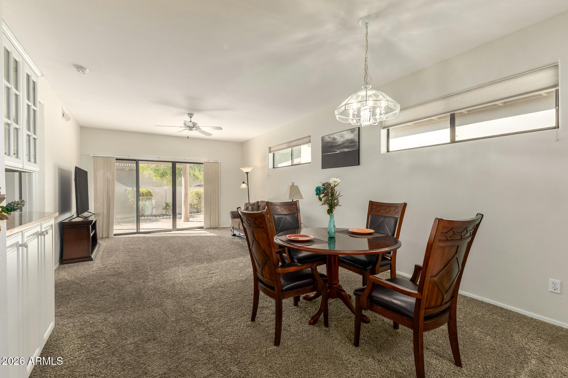 5445 East McKellips Road, Unit 23 Mesa, AZ 85215 - Photo 12 of 32 a view of a dining room with furniture and chandelier