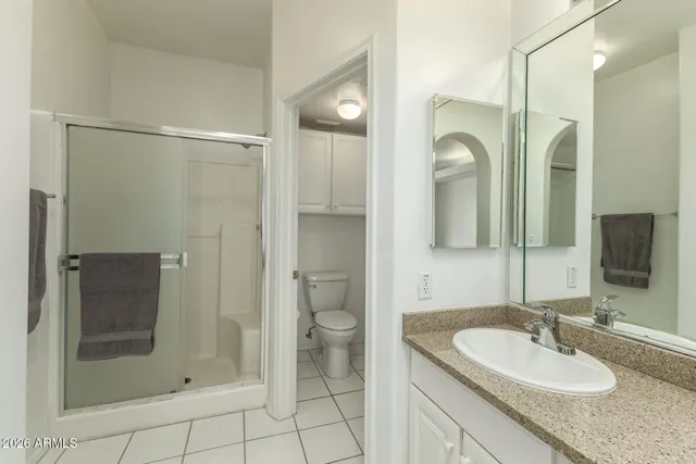 a bathroom with a shower sink and mirror