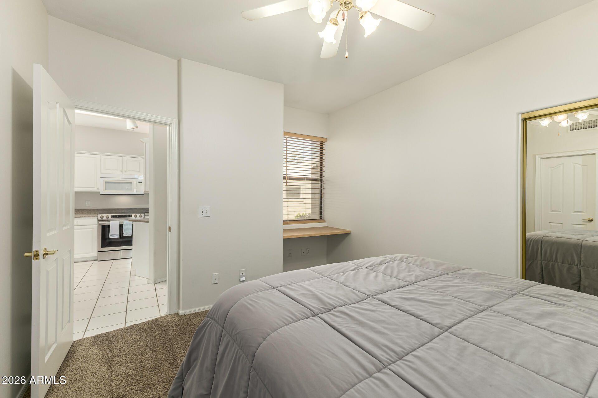 5445 East McKellips Road, Unit 23 Mesa, AZ 85215 - Photo 19 of 32 a bedroom with a large bed and a chandelier