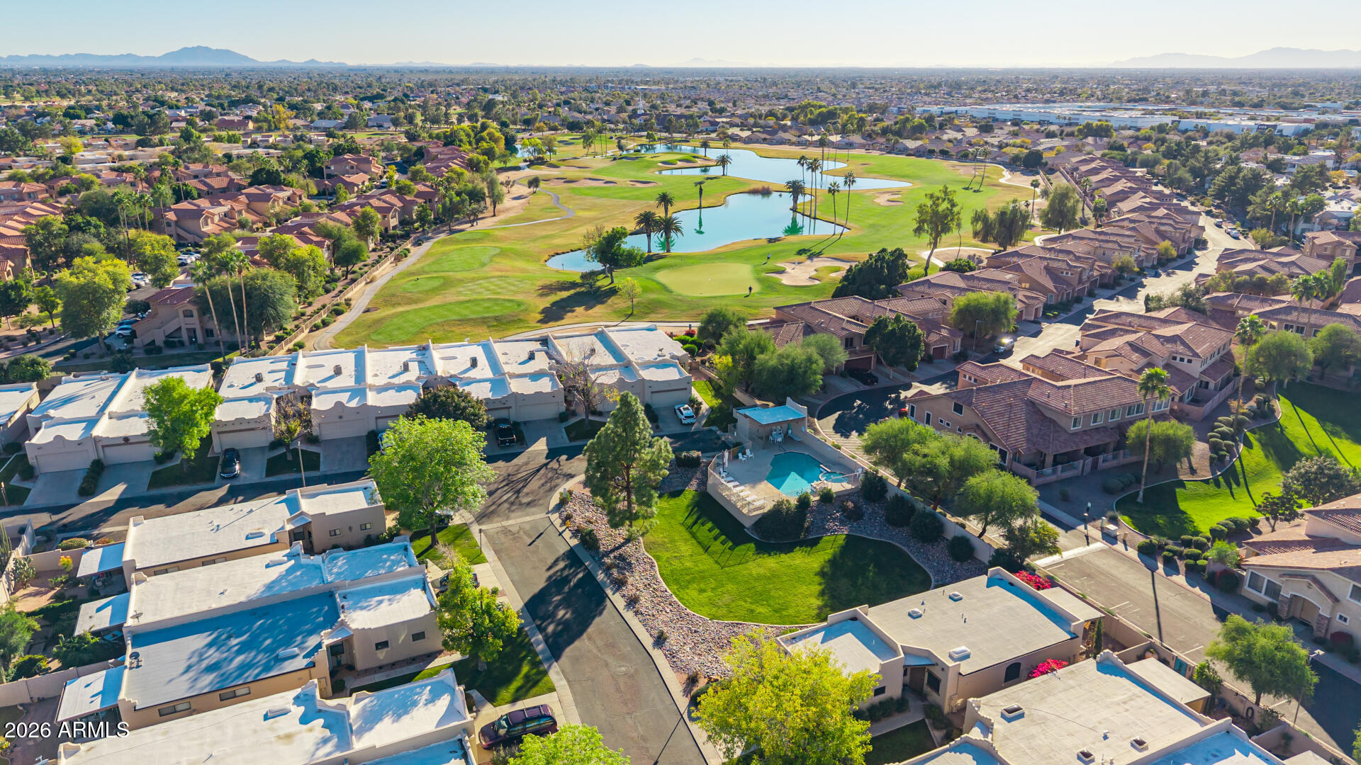 5445 East McKellips Road, Unit 23 Mesa, AZ 85215 - Photo 2 of 32 an aerial view of residential houses with outdoor space and swimming pool