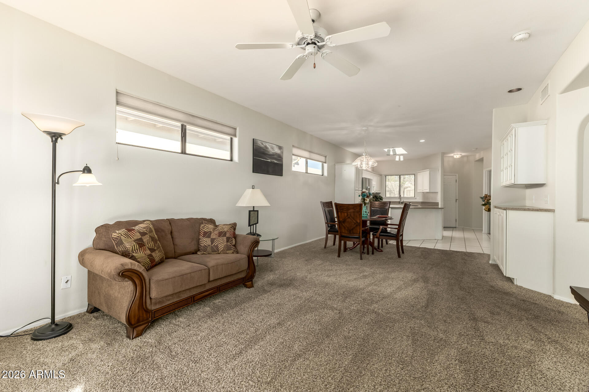 5445 East McKellips Road, Unit 23 Mesa, AZ 85215 - Photo 7 of 32 a living room with furniture and a dining table with projector kitchen