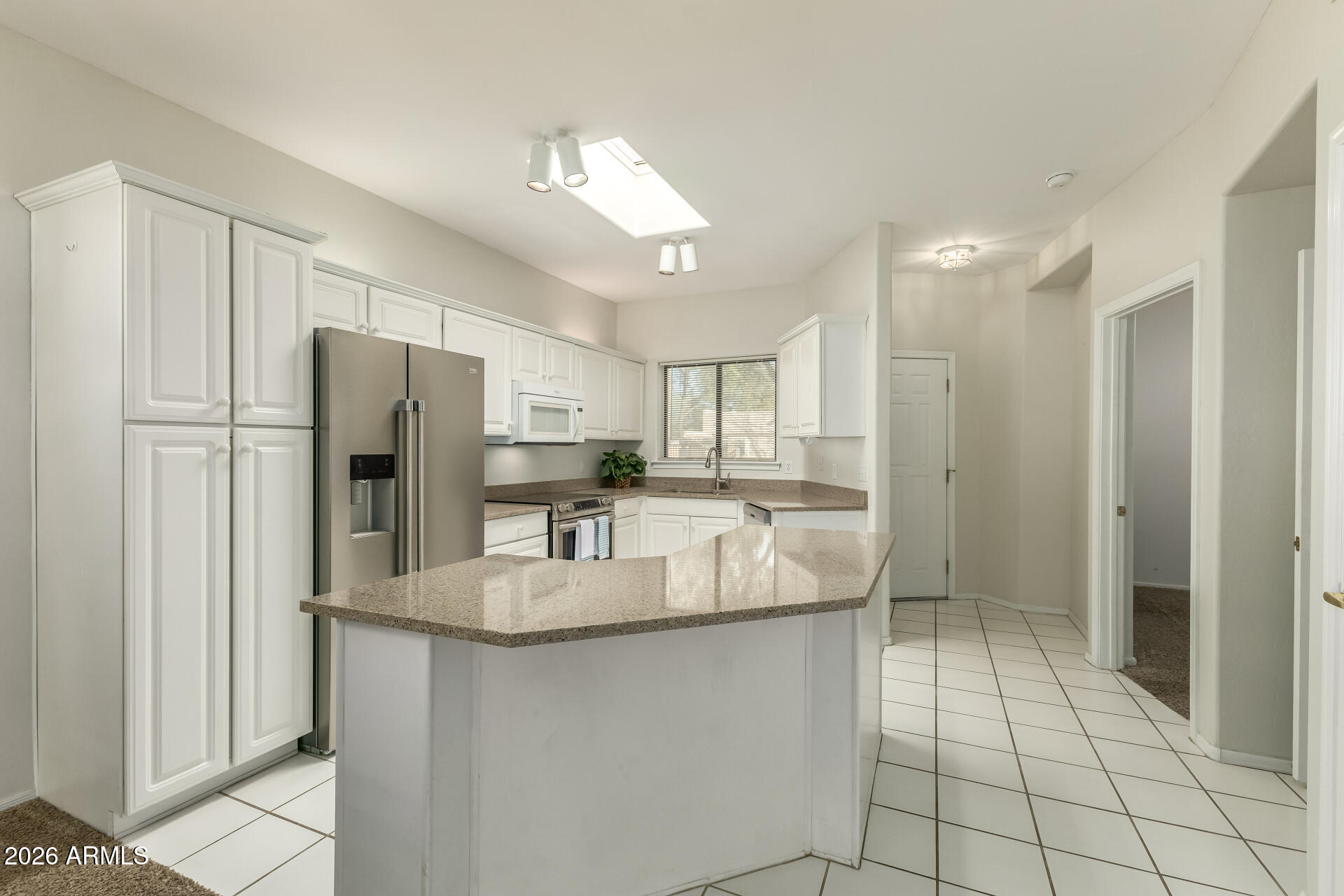 5445 East McKellips Road, Unit 23 Mesa, AZ 85215 - Photo 9 of 32 a kitchen with stainless steel appliances granite countertop a refrigerator and a sink