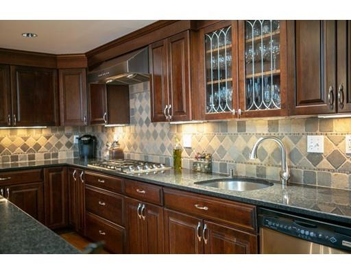 111 Sutton Road Needham, MA 02492 - Photo 13 of 30 a kitchen with granite countertop wooden cabinets and a granite counter tops