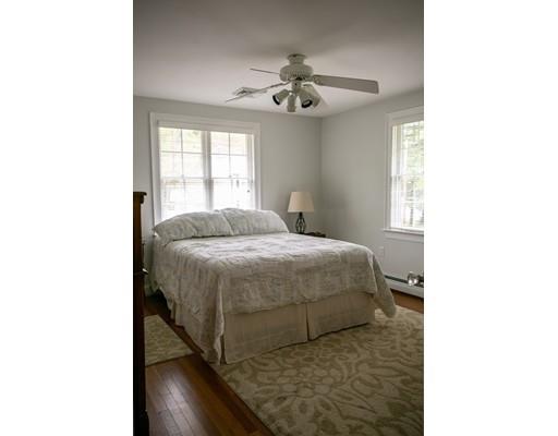 111 Sutton Road Needham, MA 02492 - Photo 22 of 30 a bedroom with a bed and a chandelier