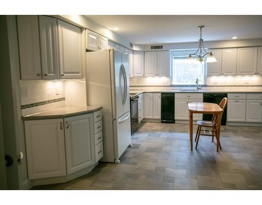111 Sutton Road Needham, MA 02492 - Photo 26 of 30 a kitchen with kitchen island granite countertop cabinets and refrigerator