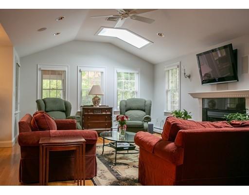 111 Sutton Road Needham, MA 02492 - Photo 9 of 30 a living room with furniture a flat screen tv and a fireplace