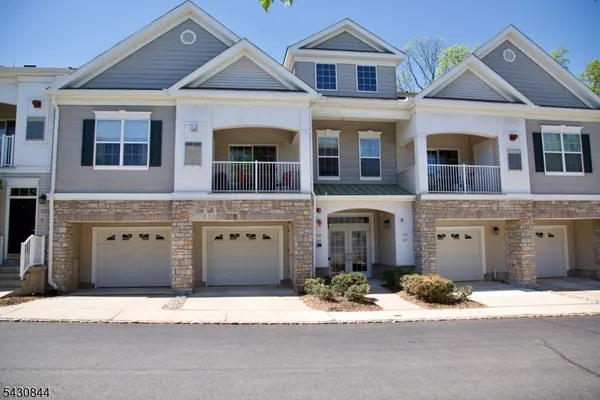 a front view of a house with a yard and a garage