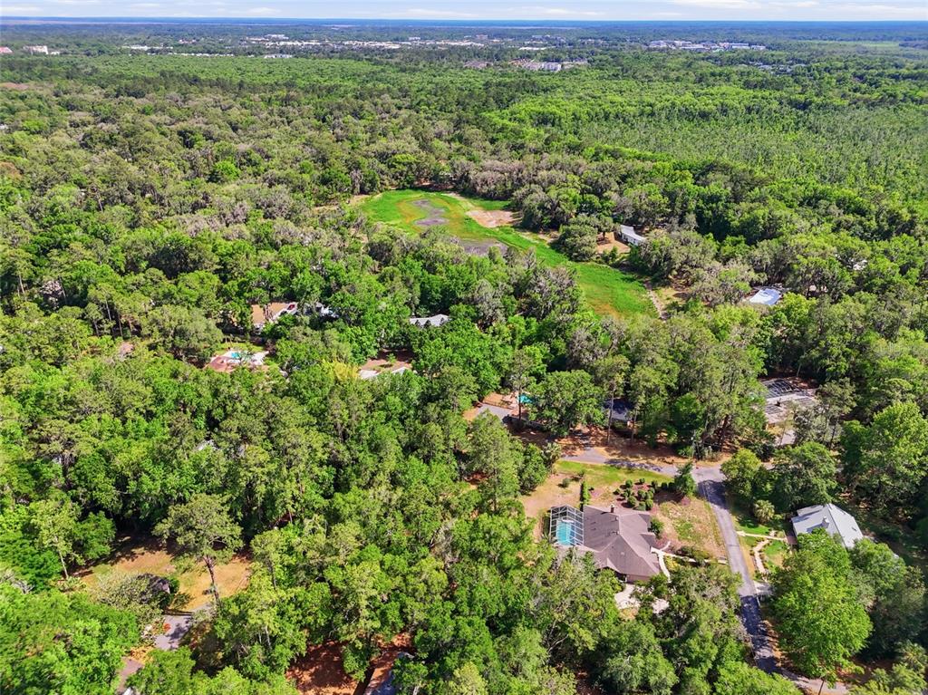 0 Northwest 45th Street Gainesville, FL 32607 - Photo 9 of 14 a view of a lush green forest with houses and lake view