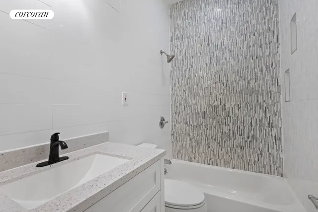 a bedroom with a bed and painting on the wall