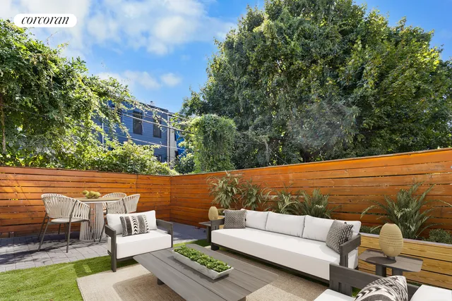 a view of a patio with table and chairs and potted plants