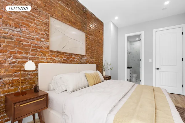 a bedroom with a bed and a night stand