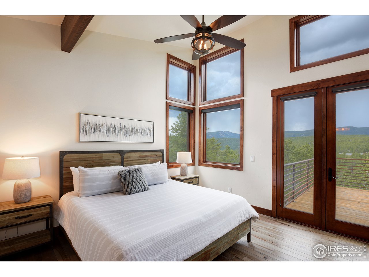 23 Ridge View Road Nederland, CO 80466 - Photo 16 of 38 a bedroom with a large bed and a window